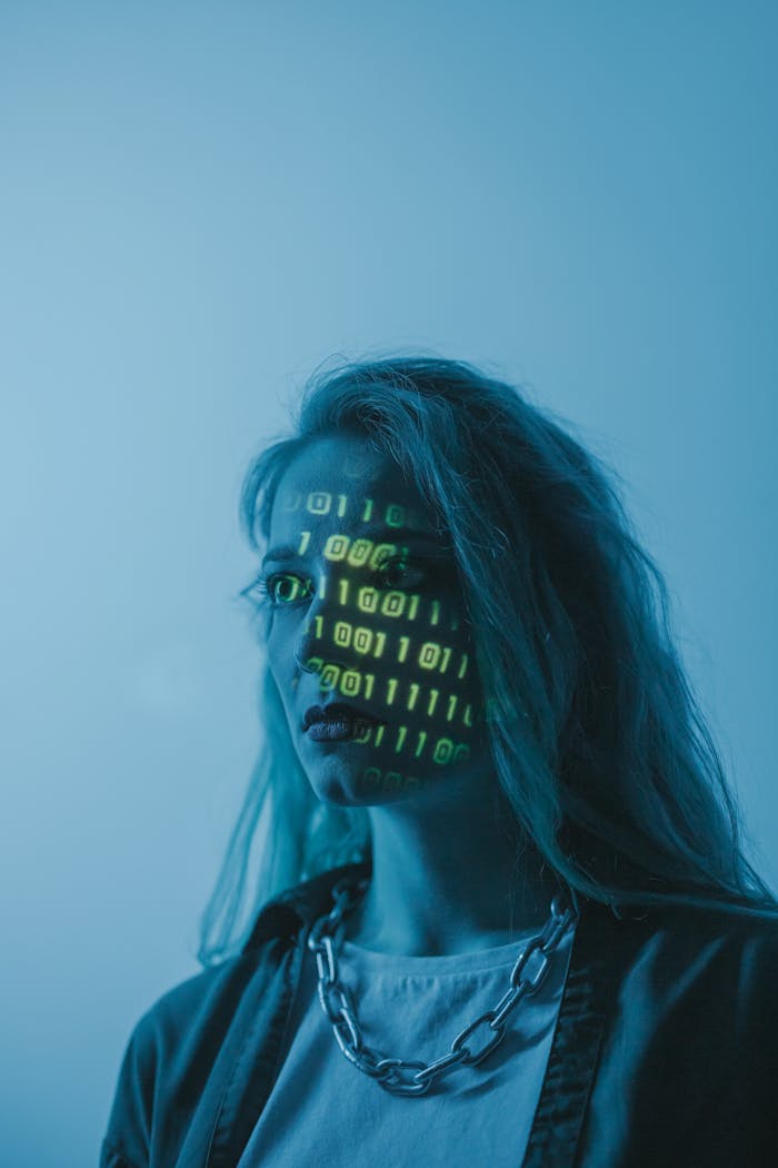 brand-03 Stylized portrait of a woman with binary code projected on her face, evoking themes of technology and identity.